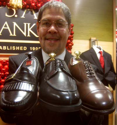 Archie Lucas, store manager for the Jos. A. Bank in downtown Washington D.C., oholds up several shoe choices. Newsline photo by Alan J. McCombs